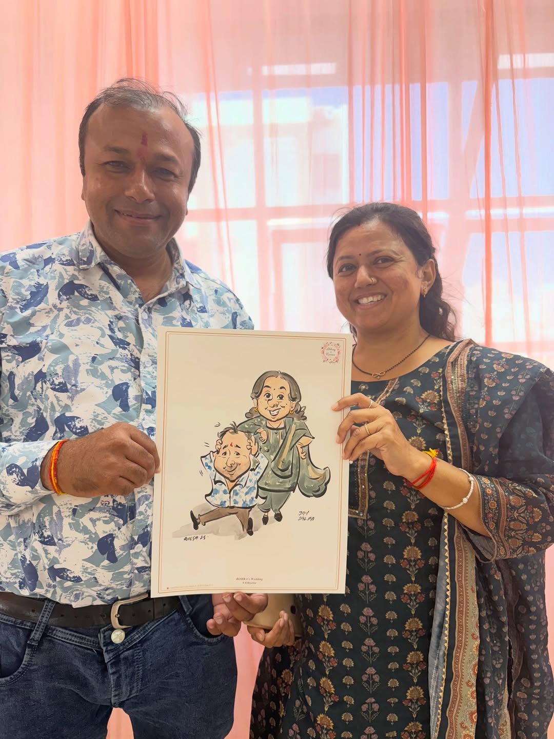 Couple at engagement event holding a hand-painted live caricature